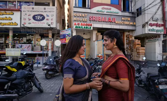 Transgender Ananya, left, and Nazariya Kutty talk before leaving for the Koothandavar temple to perform rituals during the Koovagam festival in Villupuram, in the southern Indian state of Tamil Nadu, Tuesday, April 28, 2026. (AP Photo/Mahesh Kumar A.)