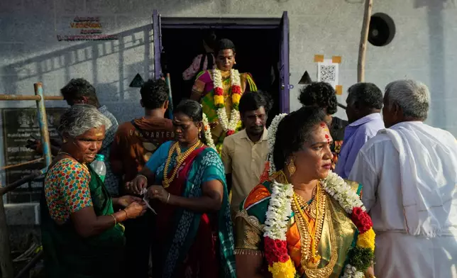 Transgender participants walk out of the Koothandavar temple after symbolically marrying the Hindu god Aravan during the Koovagam festival in Kallakurichi district in the southern Indian state of Tamil Nadu, Tuesday, April 28, 2026. (AP Photo/Mahesh Kumar A.)