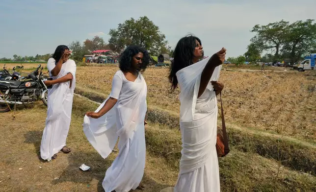 Transgender participants wear white saris to mark a symbolic ritual of widowhood during the Koovagam festival in the Kallakurichi district of southern Indian state of Tamil Nadu, Wednesday, April 29, 2026. (AP Photo/Mahesh Kumar A.)