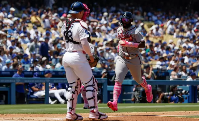 Atlanta Braves' Michael Harris II, right, runs to score on a two-run double by teammate Mauricio Dubon (not shown) during the second inning of a baseball game against the Los Angeles Dodgers, Sunday, May 10, 2026, in Los Angeles. (AP Photo/Caroline Brehman)