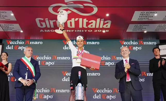 Ecuador's Manuel Jhonatan Narvaez celebrates on the podium after winning the 4th stage of the Giro d'Italia cycling race, from Catanzaro to Cosenza, Italy, Tuesday, May 12, 2026. (Gian Mattia d'Alberto/LaPresse via AP)
