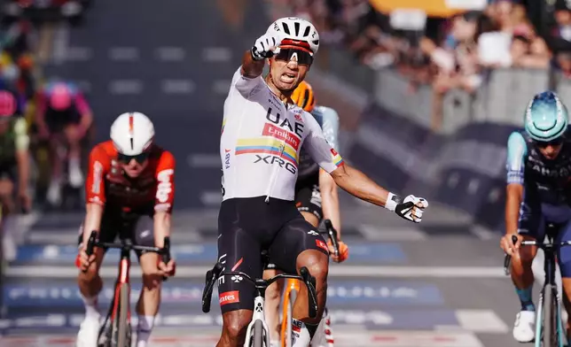 Ecuador's Manuel Jhonatan Narvaez celebrates winning the 4th stage of the Giro d'Italia cycling race, from Catanzaro to Cosenza, Italy, Tuesday, May 12, 2026. (Gian Mattia d'Alberto/LaPresse via AP)