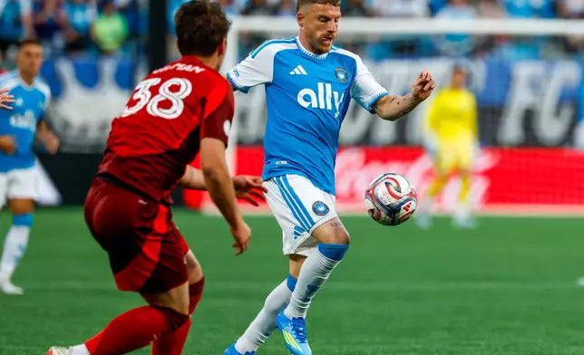 Charlotte FC midfielder Pep Biel, right, moves the ball against Toronto FC defender Jackson Gilman (38) during the first half of an MLS soccer match in Charlotte, N.C., Saturday, May 16, 2026. (AP Photo/Nell Redmond)