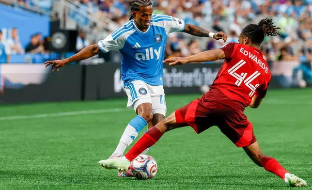 Charlotte FC forward Kerwin Vargas, left, moves the ball against Toronto FC defender Raheem Edwards (44) during the first half of an MLS soccer match in Charlotte, N.C., Saturday, May 16, 2026. (AP Photo/Nell Redmond)