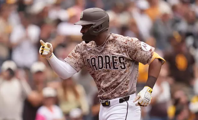 San Diego Padres' Miguel Andujar celebrates his home run during the fourth inning of a baseball game against the Chicago White Sox Sunday, May 3, 2026, in San Diego. (AP Photo/Gregory Bull)