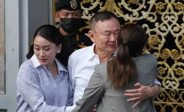 Former Thailand Prime Minister Thaksin Shinawatra, center, hugs his daughters, former Prime Minister Paetongtarn, left, and Pinthongta, after he was released on parole from a Bangkok prison in Bangkok, Thailand, Monday, May 11, 2026. (AP Photo/Sakchai Lalit)