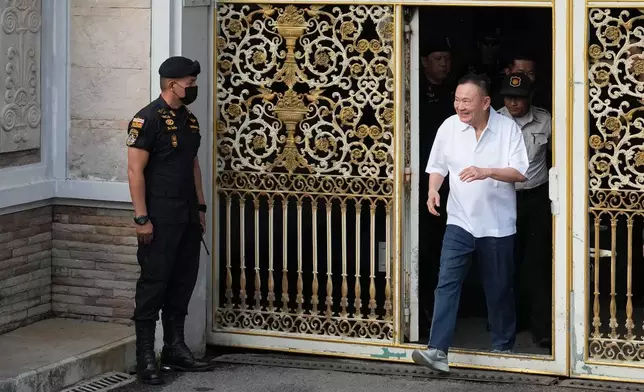 Former Thailand Prime Minister Thaksin Shinawatra walks out of a Bangkok prison as he gets released on parole in Bangkok, Thailand, Monday, May 11, 2026. (AP Photo/Sakchai Lalit)