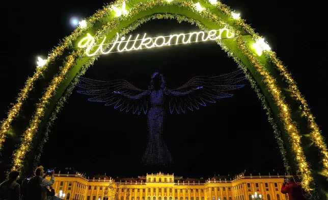 3000 drones depicts a picture of Austrian super star Concita Wurst in preparation for the upcoming Eurovision Song Contest in front of castle Schonbrunn in Vienna, Austria, Monday, April 27, 2026. (AP Photo/Matthias Schrader)