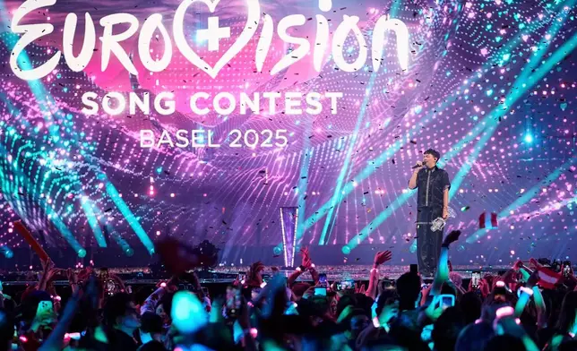 FILE - JJ from Austria stands on the stage with the trophy after winning the Grand Final of the 69th Eurovision Song Contest, in Basel, Switzerland, May 18, 2025. (AP Photo/Martin Meissner, File)