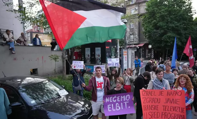 People attend a rally against Israel's participation in the Eurovision Song Contest in front of the state-run TV headquarters in Belgrade, Serbia, Tuesday, April 28, 2026. (AP Photo/Darko Vojinovic)
