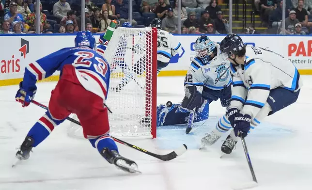 Kitchener Rangers' Sam O'Reilly (23) scores against Chicoutimi Sagueneens' goalie Lucas Beckman (32) as Christophe Berthelot (8) watches during the second period of a Memorial Cup hockey game, in Kelowna, B.C., on Tuesday, May 26, 2026. (Darryl Dyck/The Canadian Press via AP)