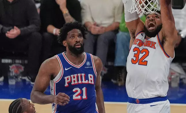 New York Knicks' Karl-Anthony Towns, right, dunk during the first half of Game 1 in a second-round NBA basketball playoffs series against the Philadelphia 76ers Monday, May 4, 2026, in New York. (AP Photo/Seth Wenig)