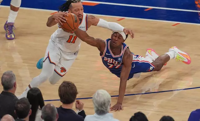 Philadelphia 76ers' Vj Edgecombe, right, fouls New York Knicks' Jalen Brunson during the first half of Game 1 in a second-round NBA basketball playoffs series Monday, May 4, 2026, in New York. (AP Photo/Seth Wenig)