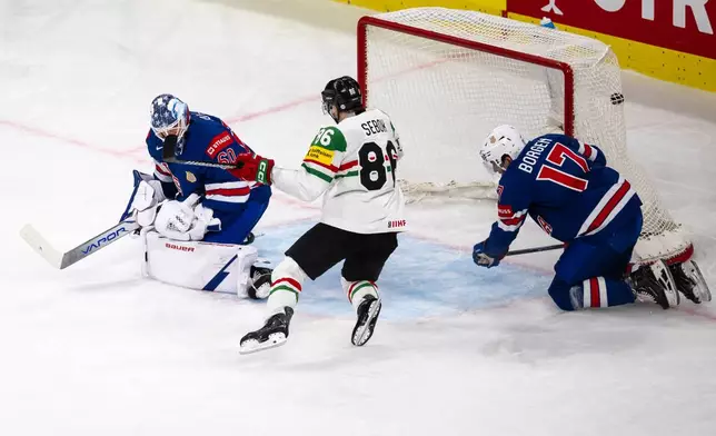 goaltender Joseph Woll of the U.S., left, concedes a goal from Hungary's Gabor Tornyai, not pictured, during the 2026 IIHF Men's Ice Hockey World Championship preliminary round group A game between United States and Hungary, in Zurich, Switzerland, Monday, May 25, 2026. (Andreas Becker/Keystone via AP)