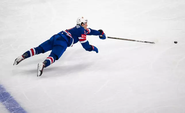 Ryan Leonard of the U.S. reaches for the puck during the 2026 IIHF Men's Ice Hockey World Championship preliminary round group A game between United States and Hungary, in Zurich, Switzerland, Monday, May 25, 2026. (Andreas Becker/Keystone via AP)