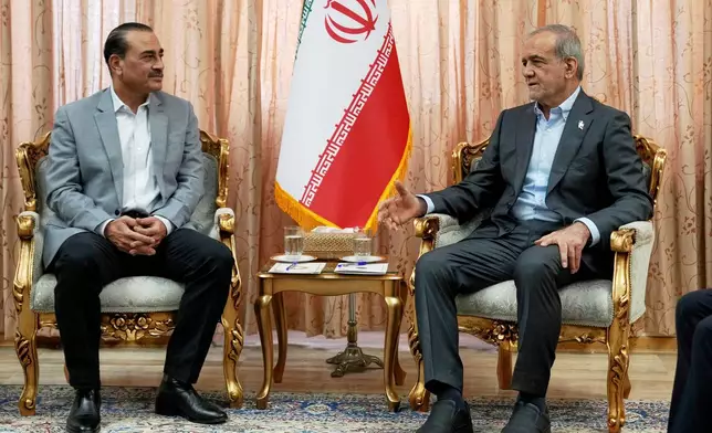 In this photo released by the Iranian Presidency Office, President Masoud Pezeshkian, right, speaks with Pakistan's Army Chief Field Marshal Gen. Asim Munir in Tehran, Iran, Saturday, May 23, 2026. (Iranian Presidency Office via AP)
