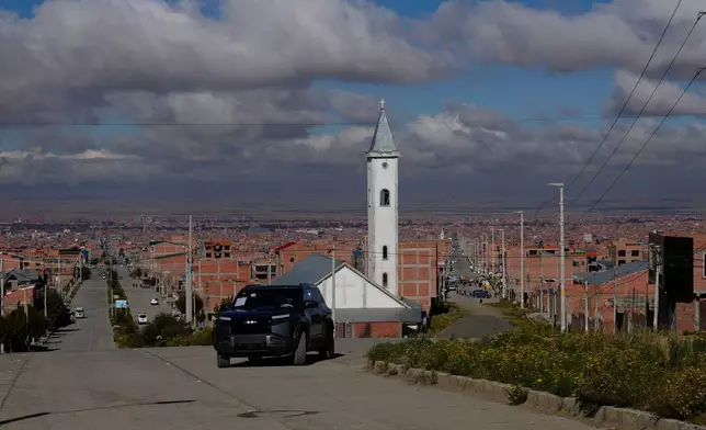 Simón Huanca drives his electric vehicle through the streets of El Alto, Bolivia, Friday, April 24, 2026. (AP Photo/Juan Karita)
