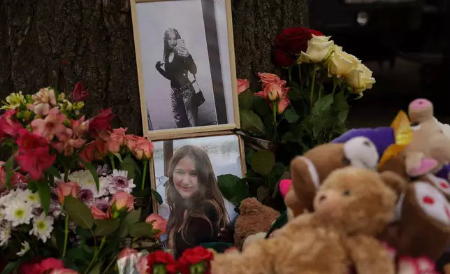 Photos of a girl who was killed are seen among flowers near a heavily damaged house after a Russian strike on a residential neighborhood in Kyiv, Ukraine, Friday, May 15, 2026. (AP Photo/Evgeniy Maloletka)