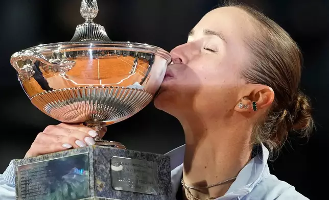 Ukraine's Elina Svitolina kisses the trophy after winning against United States' Coco Gauff at the end of the women's final match at the Italian Open tennis tournament in Rome, Saturday, May 16, 2026. (AP Photo/Alessandra Tarantino)