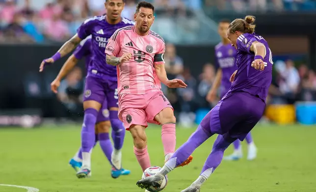 Inter Miami forward Lionel Messi (10) battles for the ball in the first half during an MLS soccer match against the Orlando City, Saturday, May 2, 2026, in Miami. (AP Photo/Chris Arjoon)