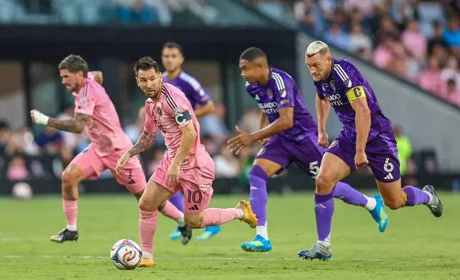 Inter Miami forward Lionel Messi (10) controls the ball as Orlando City defender Robin Jansson (6) attempts to stop in the first half during an MLS soccer match against the Orlando City, Saturday, May 2, 2026, in Miami. (AP Photo/Chris Arjoon)