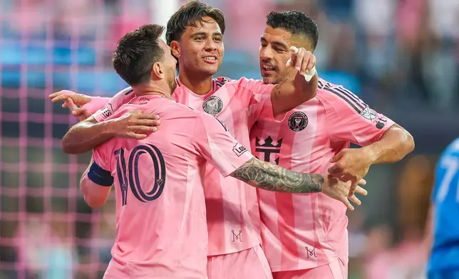 From left, Inter Miami forward Lionel Messi (10), midfielder Telasco Segovia (8) and forward Luis Suárez (9) celebrate a goal together in the first half during an MLS soccer match against the Orlando City, Saturday, May 2, 2026, in Miami. (AP Photo/Chris Arjoon)
