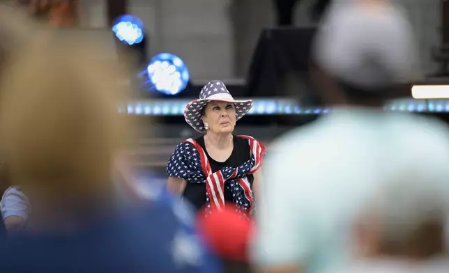 A guest attends the Rededicate 250: A National Jubilee Of Prayer, Praise &amp; Thanksgiving, Sunday, May 17, 2026, in Washington. (AP Photo/Rod Lamkey, Jr.)