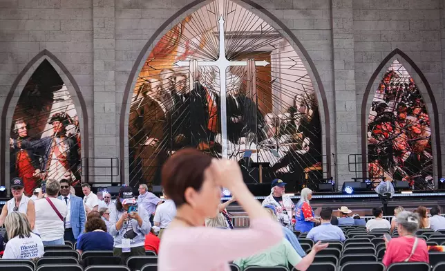A person prays during Rededicate 250, a mostly conservative Christian prayer gathering in honor of the United States' 250th anniversary, on the National Mall, Sunday, May 17, 2026, in Washington. (AP Photo/Julia Demaree Nikhinson)