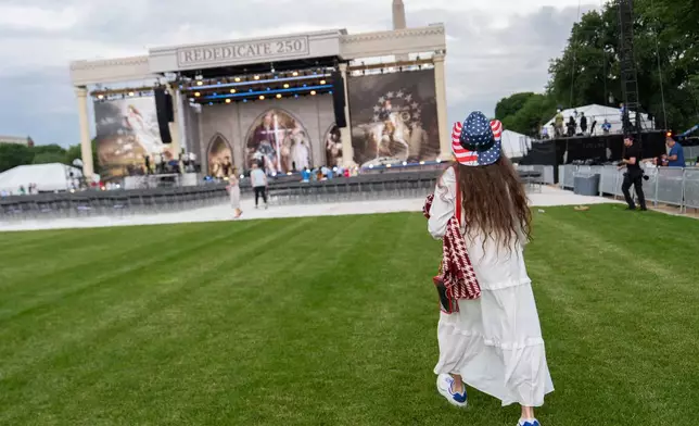 Dorothea Ohlandt, from North Carolina, arrives at Rededicate 250, a mostly conservative Christian prayer gathering in honor of the United States' 250th anniversary, on the National Mall, Sunday, May 17, 2026, in Washington. (AP Photo/Julia Demaree Nikhinson)