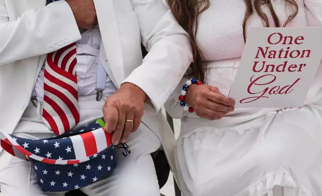 Dorothea and Billy Ohlandt, from North Carolina, arrive at Rededicate 250, a mostly conservative Christian prayer gathering in honor of the United States' 250th anniversary, on the National Mall, Sunday, May 17, 2026, in Washington. (AP Photo/Julia Demaree Nikhinson)