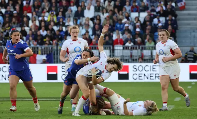 England's Ellie Kildunne is tackled during the Six Nations rugby union match between France and England in Bordeaux, Sunday, May 17, 2026. (AP Photo/Yohan Bonnet)