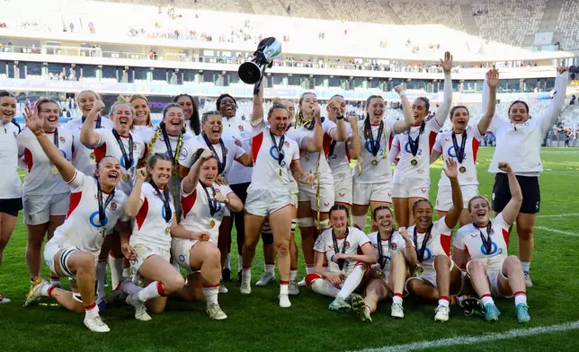 England's captain Megan Jones holds the trophy after aloft after her team won the Six Nations rugby union match between France and England in Bordeaux, Sunday, May 17, 2026. (AP Photo/Yohan Bonnet)