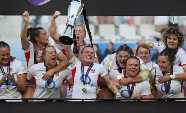 England's captain Megan Jones holds the trophy aloft after her team won the Six Nations rugby union match between France and England in Bordeaux, Sunday, May 17, 2026. (AP Photo/Yohan Bonnet)