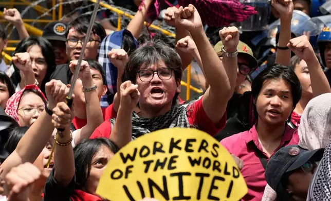 FILE - Activist and workers raise their clenched fists during a May Day rally in Manila, Philippines, May 1, 2025. (AP Photo/Aaron Favila, File)