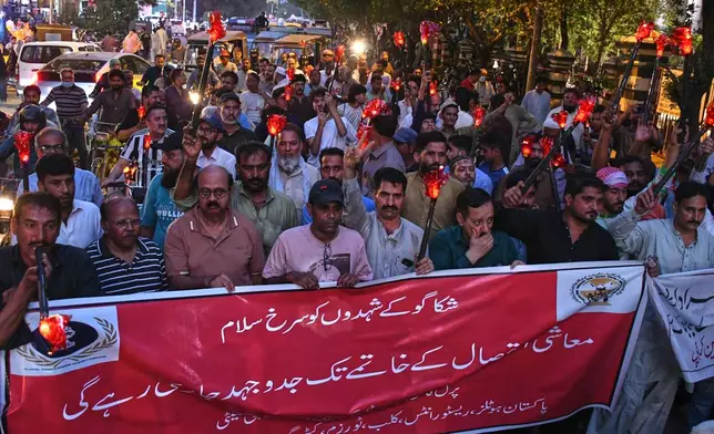 Members of trade unions take part in a rally a day ahead of the International Labor Day, in Karachi, Pakistan, Thursday, April 30, 2026. The banner in center reading as 'red salute to the martyrs of Chicago and the struggle will continue until economic exploitation is ended' (AP Photo/Ali Raza)