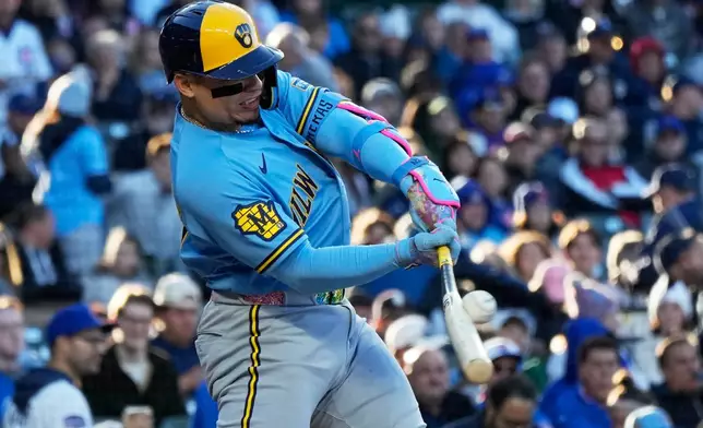Milwaukee Brewers' William Contreras hits a single during the first inning of a baseball game against the Chicago Cubs in Chicago, Wednesday, May 20, 2026. (AP Photo/Nam Y. Huh)