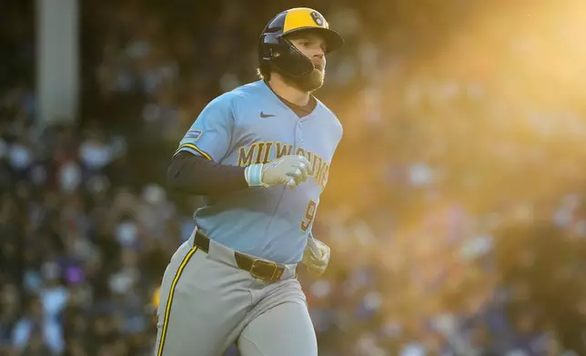 Milwaukee Brewers' Jake Bauers runs after hitting a one-run single during the third inning of a baseball game against the Chicago Cubs in Chicago, Wednesday, May 20, 2026. (AP Photo/Nam Y. Huh)