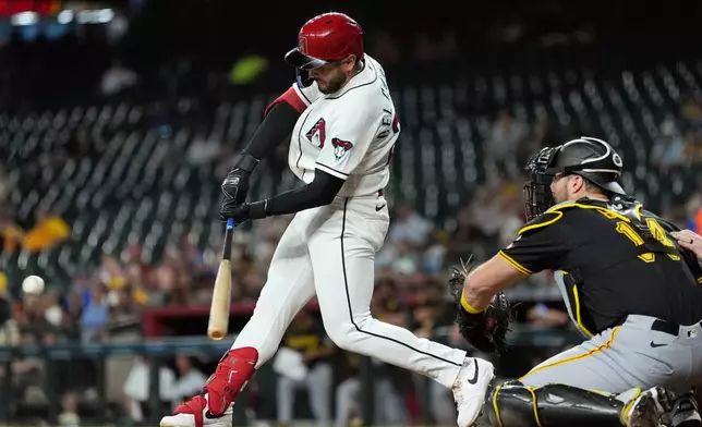 Arizona Diamondbacks' Adrian Del Castillo, left, connects for a run-scoring single as Pittsburgh Pirates catcher Joey Bart (14) reaches for the ball during the first inning of a baseball game, Thursday, May 7, 2026, in Phoenix. (AP Photo/Ross D. Franklin)