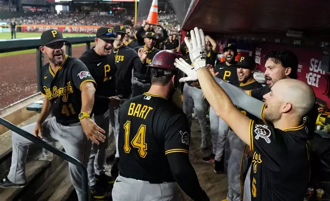 Pittsburgh Pirates' Joey Bart (14) celebrates his home run against the Arizona Diamondbacks with Pirates bench coach Kristopher Negrón (41) and Pirates' Brandon Lowe (5)during the sixth inning of a baseball game, Thursday, May 7, 2026, in Phoenix. (AP Photo/Ross D. Franklin)