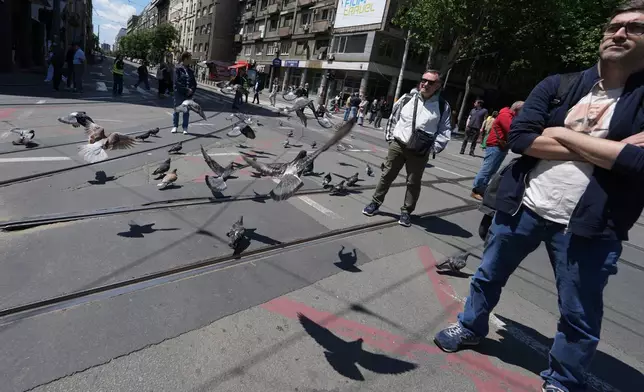 University students and citizens stand in silence during commemorative traffic blockade to a train station tragedy that killed 16 people before the first big rally this year of opponents of President Aleksandar Vucic in Belgrade, Serbia, Monday, May 18, 2026. (AP Photo/Darko Vojinovic)