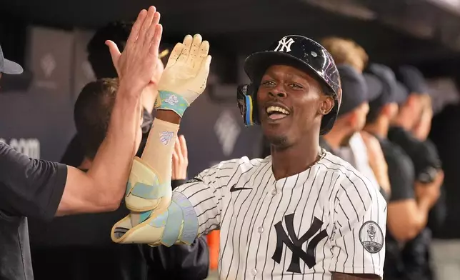New York Yankees' Jazz Chisholm Jr. celebrates his two-run home run in the dugout during the seventh inning of a baseball game against the Toronto Blue Jays, Monday, May 18, 2026, in New York. (AP Photo/Seth Wenig)
