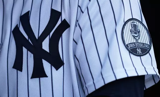 A patch memorializing John Sterling, the long-time New York Yankees radio announcer, is seen on a uniform before a baseball game against the Toronto Blue Jays, Monday, May 18, 2026, in New York. (AP Photo/Seth Wenig)