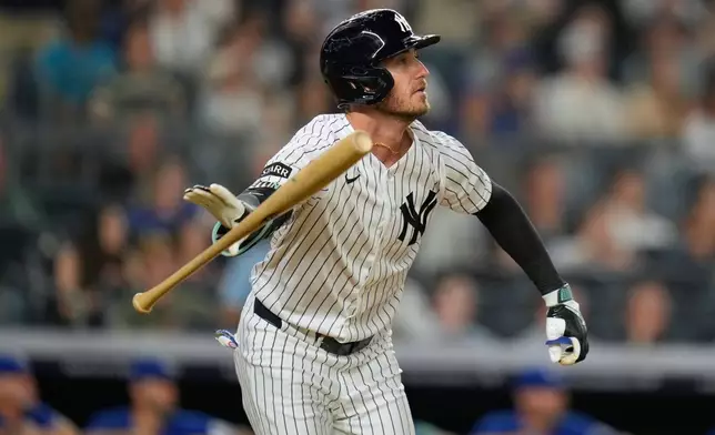 New York Yankees' Cody Bellinger looks after his two-run homer during the seventh inning of a baseball game against the Toronto Blue Jays, Monday, May 18, 2026, in New York. (AP Photo/Seth Wenig)