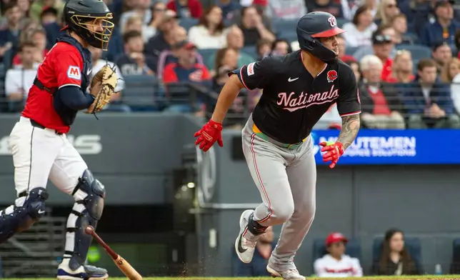 Washington Nationals' Luis Garcia Jr., right, watches his two-run single off Cleveland Guardians relief pitcher Logan Allen as catcher Patrick Bailey look on during the sixth inning of a baseball game, Monday, May 25, 2026, in Cleveland. (AP Photo/Phil Long)