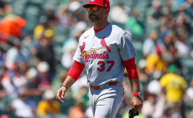 St. Louis Cardinals manger Oliver Marmol walks to the dugout after making a pitching change during the seventh inning of a baseball game against the Athletics, Thursday, May 14, 2026, in West Sacramento, Calif. (AP Photo/Scott Marshall)