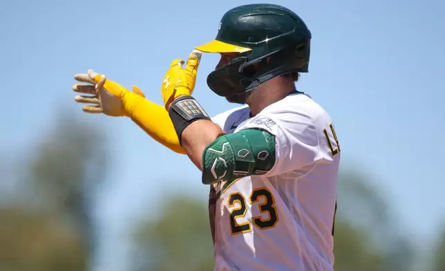 Athletics' Shea Langeliers gestures towards his dugout after hitting a two RBI single during the seventh inning of a baseball game against the St. Louis Cardinals, Thursday, May 14, 2026, in West Sacramento, Calif. (AP Photo/Scott Marshall)