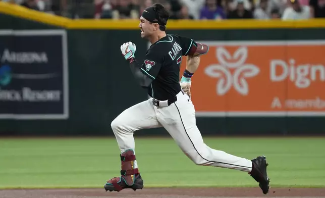 Arizona Diamondbacks' Corbin Carroll runs after hitting a triple against the Colorado Rockies in the first inning of a baseball game, Sunday, May 24, 2026, in Phoenix. (AP Photo/Rick Scuteri)