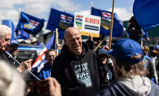 Mitch Sylvestre talks with supporters before he submits his signatures for a separation referendum to Elections Alberta in Edmonton, on Monday, May 4, 2026. (Jason Franson/The Canadian Press via AP)