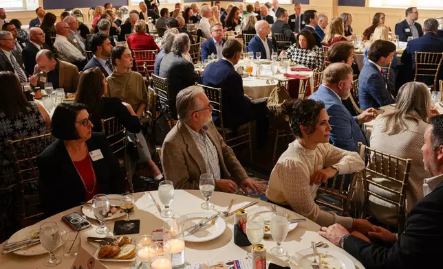 Guests look on as candidates speak on stage during the Kenton County Republican Party Lincoln Day Dinner, Thursday, April 30, 2026, in Covington, Ky. (AP Photo/Jon Cherry)
