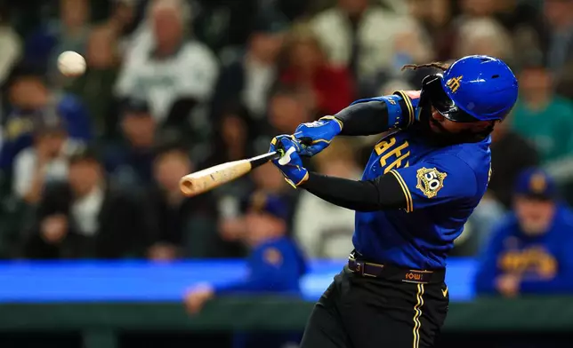 Seattle Mariners' J.P. Crawford hits a one-run home run against the Arizona Diamondbacks during the first inning of a baseball game Friday, May 29, 2026, in Seattle. (AP Photo/Caean Couto)